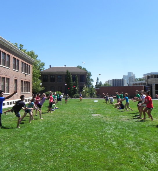 A group of students tossing water balloons