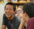A boy smiling at another student