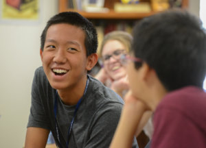 A boy smiling at another student
