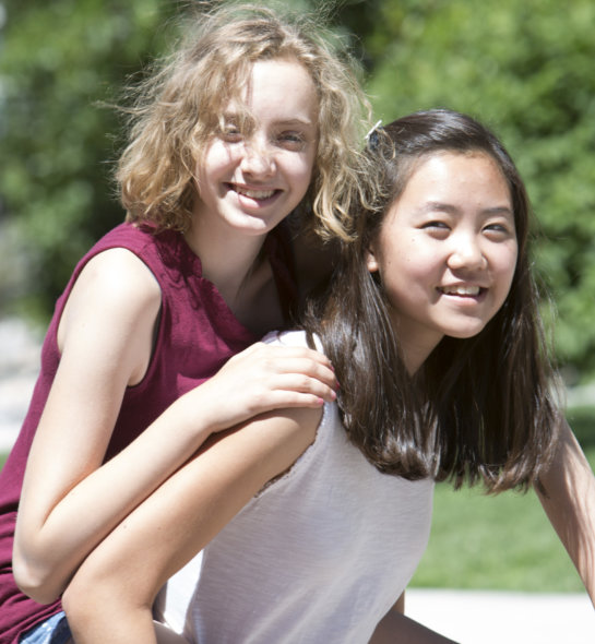 Two girls smiling while outside