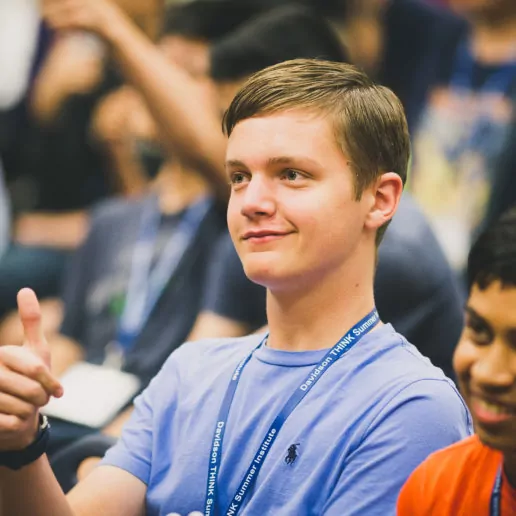 A boy giving a thumbs up