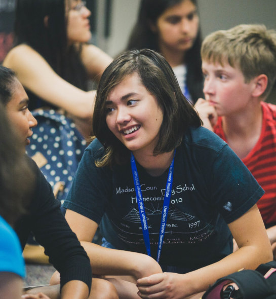 A young girl interacting with other students at the Davidson Institute