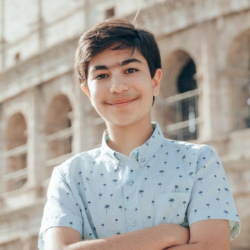 Teenage boy smiling with arms crossed