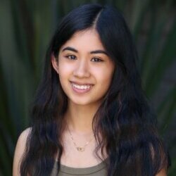 Teenage girl smiling with a plant background