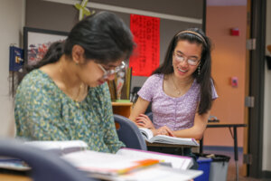 Two girls working on a class assignment together