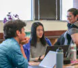 Students and teacher at a table in the classroom